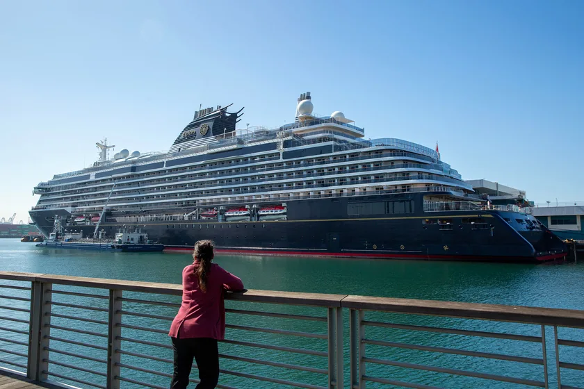 A visitor watches a docked cruise ship from the Port of Los Angeles waterfront promenade.